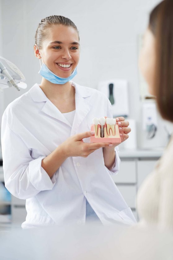 Zahnarzt zeigt Folgen von Zähneknirschen